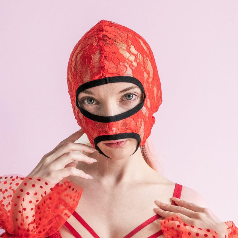 A handmade red mask with an exposed mouth and eyes.73