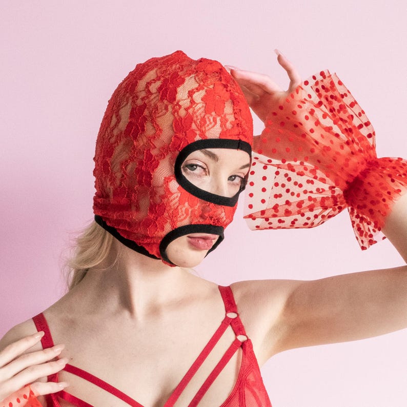 A handmade red mask with an exposed mouth and eyes.73