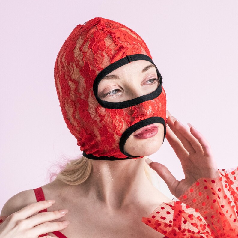 A handmade red mask with an exposed mouth and eyes.73