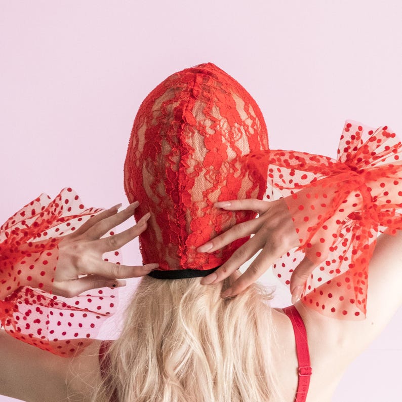 A handmade red mask with an exposed mouth and eyes.73