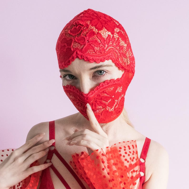 A handmade red mask, only revealing the eyes.75