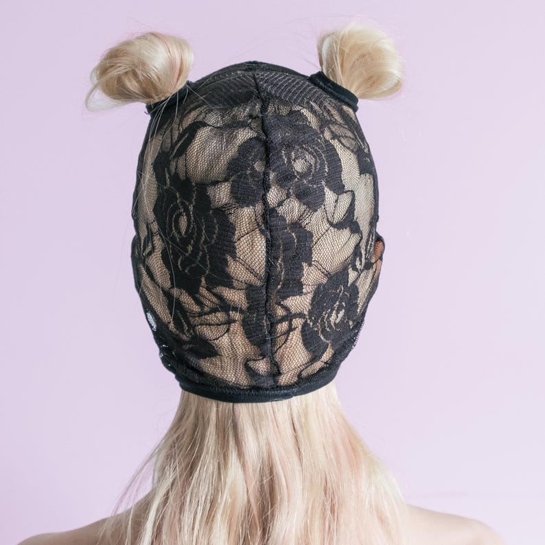 A handmade black mask with holes for letting hair through.76