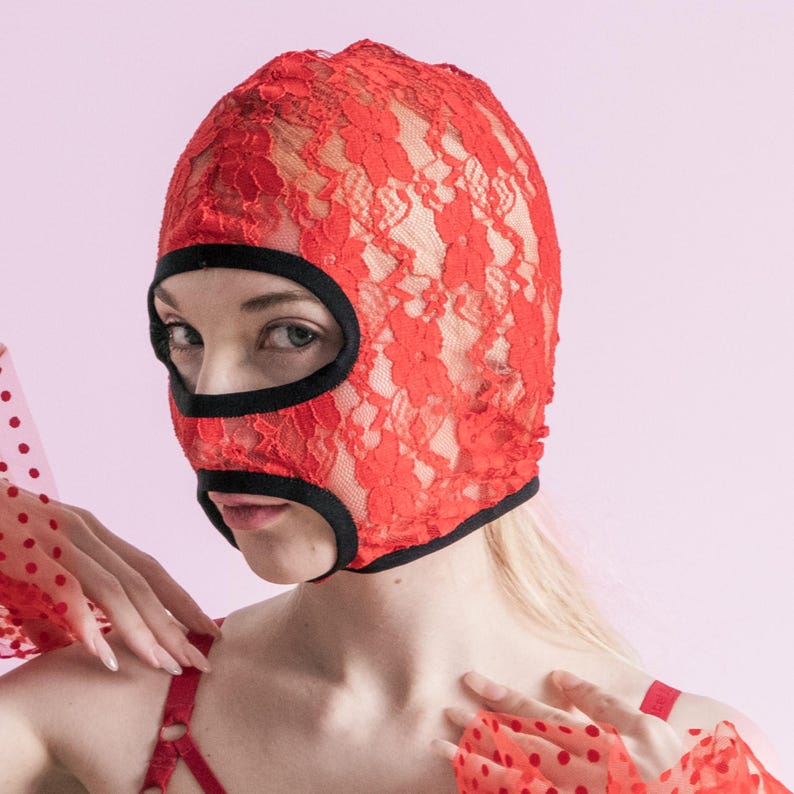 A handmade red mask with an exposed mouth and eyes.73