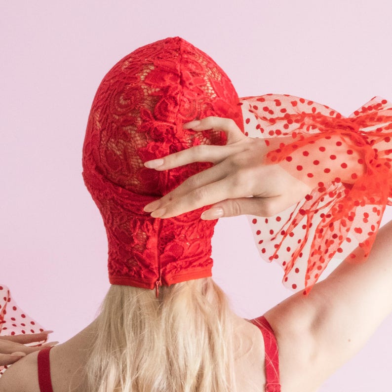 A handmade red mask, only revealing the eyes.75